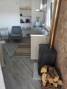 a kitchen with a wood stove in a room at Casas Zé Pinto in Hospital