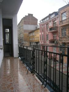 a balcony with a black fence and buildings at Ivory Tower Hostel in Sofia