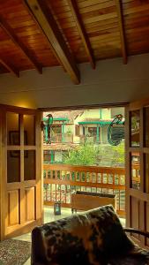 a living room with a view of a house at La Casa Amarilla in Jardin