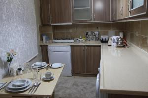 a small kitchen with a table with dishes on it at Kinzi House in Çanakkale