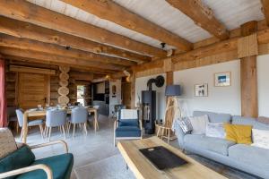 a living room with a couch and a table at Chalet L'Axurit - Familial Jacuzzi Sauna in La Cabanasse