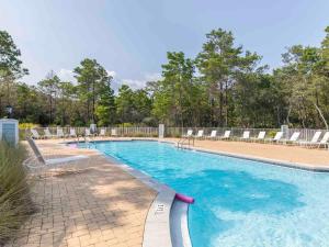 a large swimming pool with lounge chairs at Sea La Vie In Grayton Beach in Santa Rosa Beach