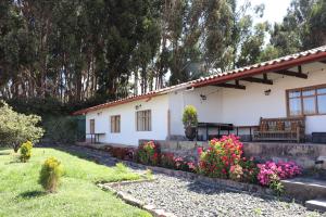 a white house with flowers in front of it at Palacio Manco Capac by Ananay Hotels in Cusco