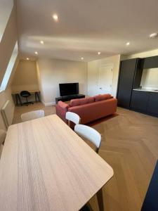 a living room with a couch and a table at Apartments in the heart of Richmond, London in Richmond upon Thames