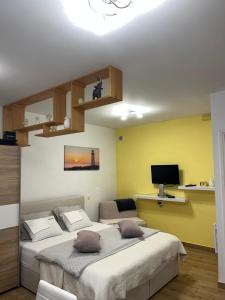 a bedroom with two beds and a television in it at Lovre in Viskovo