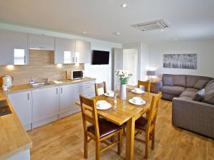 a kitchen and a living room with a table and a couch at Rockworks Chalets No,6 - Uk7045 in Saint Marys