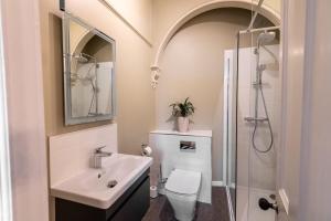 a bathroom with a sink and a toilet and a shower at Stylish Central 2 Bedroom Apartment in Hereford