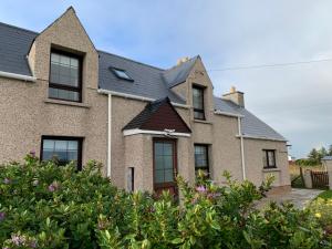 a brick house with a pitched roof at Sighthill Cottage, North Tolsta in Stornoway