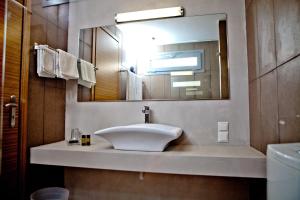 a bathroom with a sink and a mirror at Xanthippi Hotel in Souvala