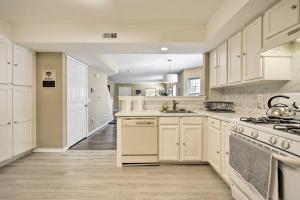 a kitchen with white cabinets and a stove top oven at Atlantic City Home - Close to Casinos and Beach in Atlantic City