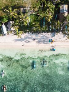 an aerial view of a beach with boats in the water at Blue Moon Inn in Dauis