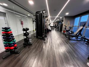 a gym with treadmills and machines in a room at Apt moderno 900m Vila Germânica Oktoberfest in Blumenau