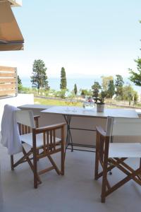 a table and chairs with a view of the ocean at Xanthippi Hotel in Souvala