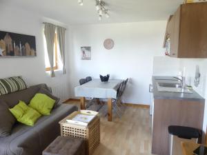 a living room with a couch and a table at Chalet Le Télémark in Thollon