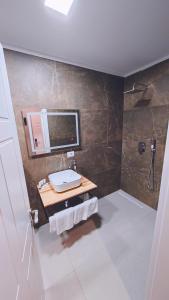 a bathroom with a sink and a mirror at Vila Casablanca - Boutique Hotel & Restaurant in Shkodër