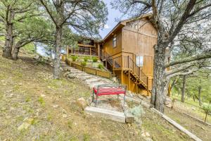 a house with a red bench in front of it at Living the Dream, 3 Bedrooms, Hot Tub, Fireplace, Sleeps 6 in Ruidoso
