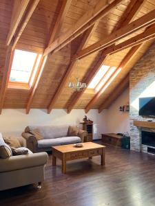 a living room with two couches and a coffee table at Apartmán pod orechom in Drienica