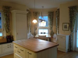 a kitchen with a island in the middle of a room at Villa Rauter Mayrhofen in Mayrhofen