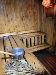 a inside of a wooden sauna with a bucket at Karula Stay Sauna House in Karula National Park in Ähijärve