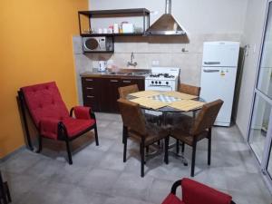 a kitchen with a table and chairs and a refrigerator at San Rafael Ciudad in San Rafael