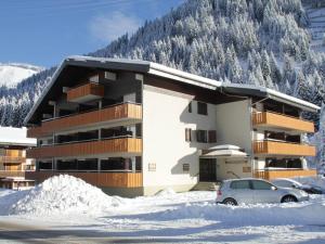 um edifício na neve com um carro estacionado na frente em Appartement Châtel, 2 pièces, 6 personnes - FR-1-200-211 em Châtel