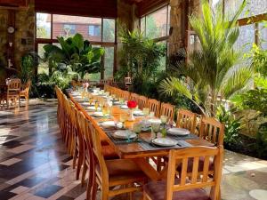 a long wooden table in a room with plants at Grig House Eco Resort in Gyulagarak