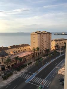 a city street with buildings and the ocean in the background at Apartamento Vistamar in La Manga del Mar Menor +24 photos