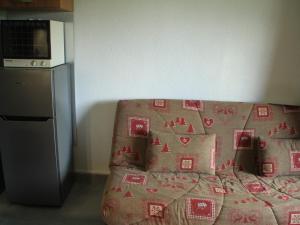 een woonkamer met een bank en een magnetron bij Studio Châtel, 1 pièce, 3 personnes - FR-1-200-316 in Châtel