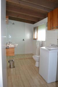 a bathroom with a sink and a toilet at Chris's Beacon Point Restaurant & Villas in Apollo Bay