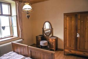a bedroom with a mirror and a bed and a dresser at Marx Bauernhaus 