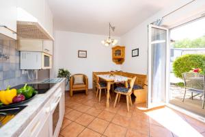 a kitchen with a table and a dining room at Appartements Walzl in Maria Lankowitz