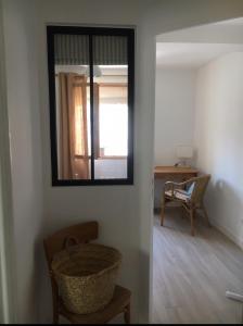 a mirror on a wall in a room with a chair at Maison de charme en bord de Mer in Le Barcarès +11 photos