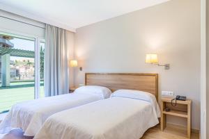 Posteľ alebo postele v izbe v ubytovaní HOTEL JAUME D'URGELL