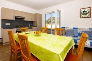 a kitchen and dining room with a table and chairs at Appartmenthaus Köflach in Köflach