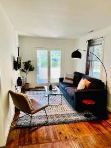 sala de estar con sofá y silla en Modern Cottage The Whitney by The Bay, en Villas