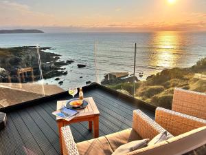 a balcony with a table and a view of the ocean at Watersmeet Hotel in Woolacombe