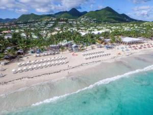 an aerial view of a beach with chairs and umbrellas at Villa Zami in Saint Martin