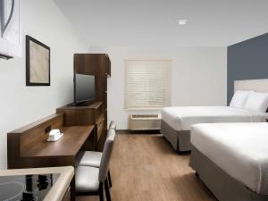 a hotel room with two beds and a desk at Extended Stay America Suites - New Orleans - Airport - I-10 in Kenner