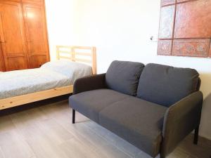un divano e un letto in una camera di Estudio Don Antonio en el centro de La Laguna a La Laguna