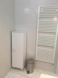 a kitchen with a white refrigerator and a trash can at Apartman Sveti Rok in Zagreb