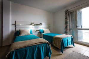 מיטה או מיטות בחדר ב-Casa Los Mangos - Increíbles vistas