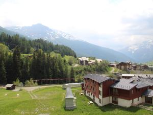 - une vue sur un village avec des montagnes en arrière-plan dans l'établissement Studio Lanslevillard, 1 pièce, 3 personnes - FR-1-508-182, à Lanslevillard