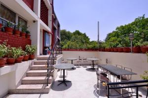 a patio with tables and tables on a building at HOTEL ARINA in Chandīgarh