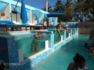 a man standing in a swimming pool at a resort at El Cabarete Boutique Hotel in Cabarete +7 photos