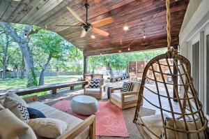 un portico con divano e ventilatore a soffitto di Buda Home with Deck and Fire Pit - 15 Mi to Austin! a Buda