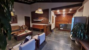 a living room with a boat on the wall at Taipabas Hotel in Barra Grande