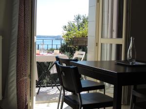 a room with a table and chairs and a balcony at Villa Rosa in Moniga