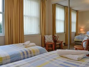 a hotel room with two beds and a mirror at Cilgwyn in Llandecwyn