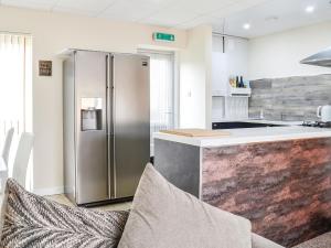 a kitchen with a stainless steel refrigerator next to a counter at 1 Ladyknowe - Uk39970 in Moffat