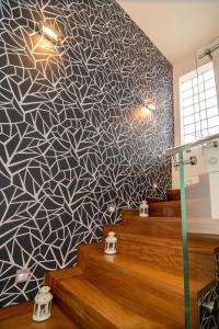 a room with a patterned wall with stairs and lights at Optasia Luxury House in Argos +9 photos